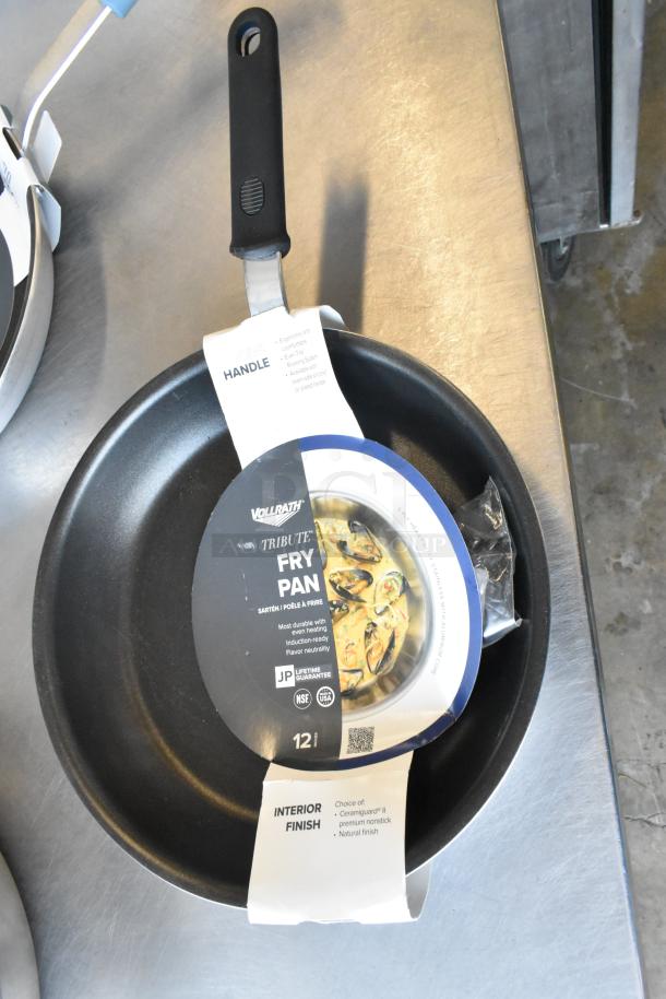 Brand new Vollrath Tribute Fry Pan with non-stick coating, ergonomic handle, and handle label visible.
