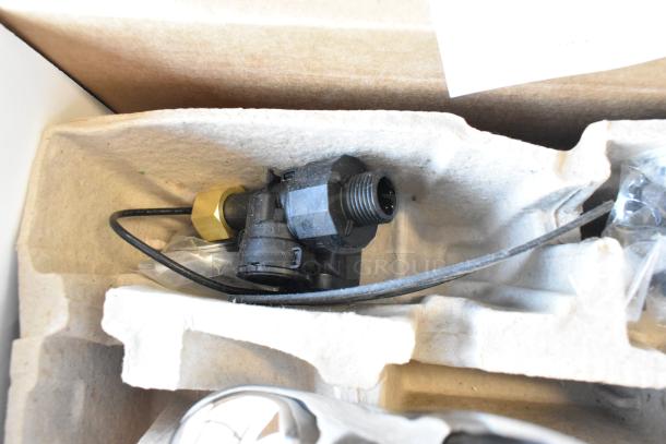 New Zurn ZG6955 faucet parts in packaging; visible wiring and brass fitting. Scratch and dent condition.