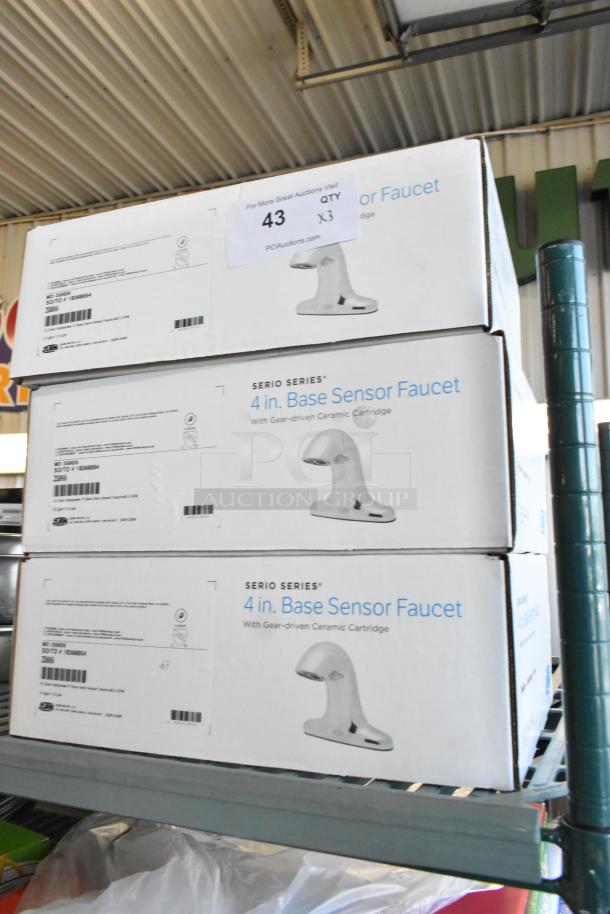 Three Zurn ZG6955 faucets in boxes. Scratch and dent condition. Serio Series 4-inch base sensor faucets. Quantity label: 3X.