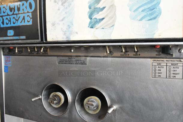 Electro Freeze 30TN-CAB-113 stainless steel soft serve ice cream machine, 2 flavor with twist, on commercial casters.