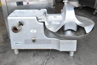 Univex metal commercial countertop buffalo chopper with S blade, showing moderate wear, Univex branding visible on casing.