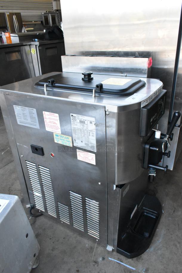 Taylor C709-27 stainless steel soft serve machine, countertop model, air-cooled, single flavor, 208-230V, 1 phase, with labels visible.
