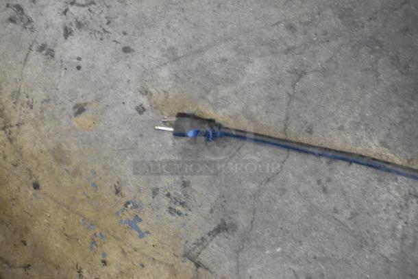 Alt text: Power plug and cord on a concrete floor, possibly for a Bunn ITCB-DV iced tea machine.
