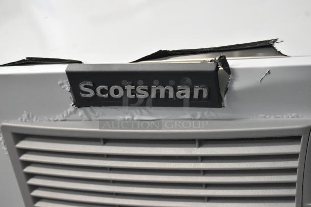 BRAND NEW SCRATCH AND DENT Scotsman MC1030SA-32A Ice Machine, 30", 1077 lb capacity, visible dents on surface, logo on front.