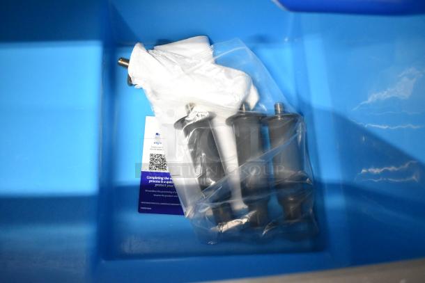 Manitowoc UDF0310A-261Z ice machine parts in a bag, inside blue bin; ice machine is scratch and dent, 2023 model.