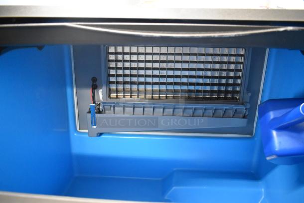Manitowoc UDF0310A-261Z ice machine interior, showing steel grid for dice cubes. Blue bin, new condition, 2023 model.