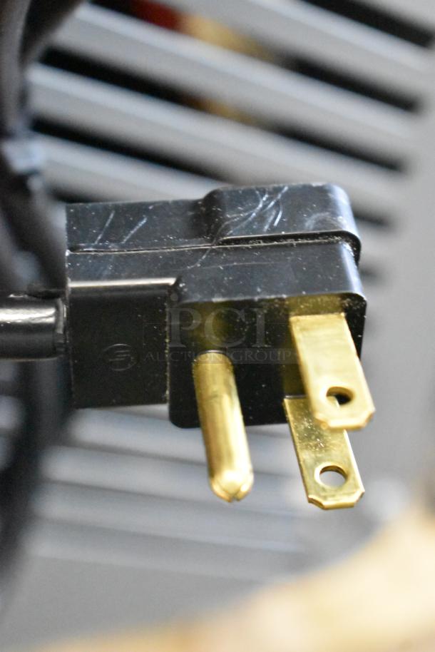 Close-up of a power plug for a Beverage-Air DD78HC-1-S kegerator, showing metal prongs and a black casing.