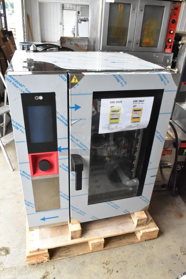Brand new Blodgett AETE101R stainless steel electric combi oven, 208V, 3 phase, with visible scratch and dent.