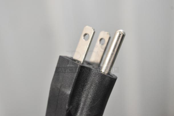 Close-up of a three-prong plug for the Avantco 189BVAC46HC commercial merchandiser, designed for 110-120 volts, 1 phase.