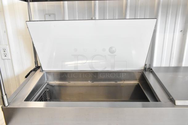 2024 Avantco 178SSPPT2 stainless steel pizza prep table, open lid view, showing interior space and construction quality.