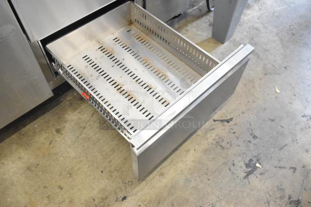 2024 Avantco 178SSPPT2 stainless steel pizza prep table drawer detail, includes oversized cutting board and 2-tier overshelf.