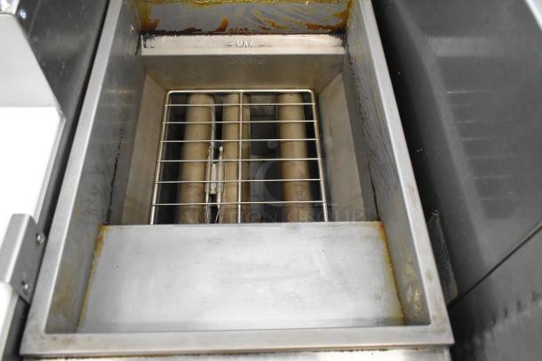 2024 Avantco 177FF40L stainless steel propane gas deep fat fryer interior view, showing metal heating elements and oil residue.