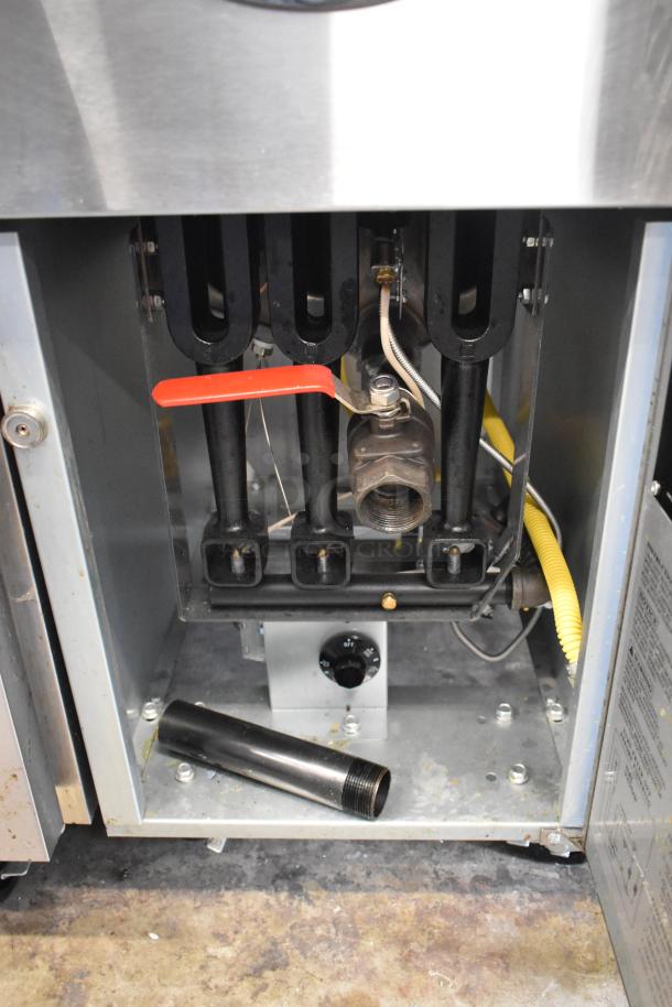 2024 Avantco 177FF40L stainless steel commercial propane gas fryer, 90,000 BTU, open panel view, features metal fry baskets.