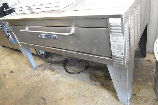Bakers Pride EP8-5736 stainless steel single deck pizza oven with cooking stones on metal legs, 208V, 3 phase.