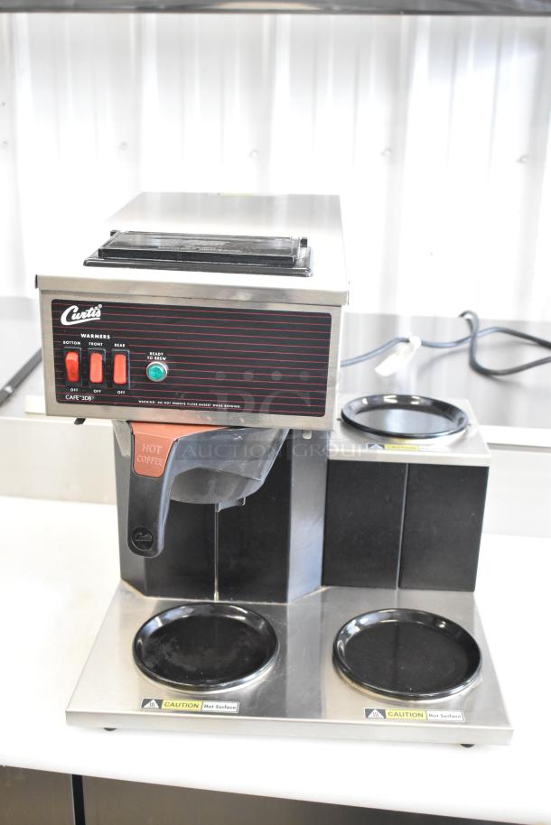 Curtis CAFE3DB10A000 3 burner stainless steel countertop range with poly brew basket; 120V, 1 phase; excellent condition.