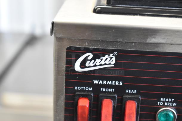Curtis CAFE3DB10A000 stainless steel 3 burner range. Control panel with labeled switches: bottom, front, rear warmers.