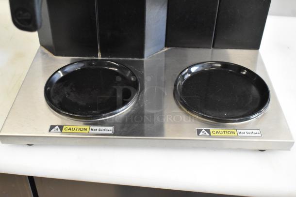 Curtis CAFE3DB10A000 stainless steel 3-burner range with poly brew basket. Features "Caution Hot Surface" labels.