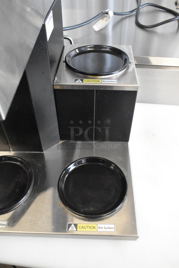 Curtis CAFE3DB10A000 stainless steel commercial 3 burner range with poly brew basket, labels indicate "Caution: Hot Surface."