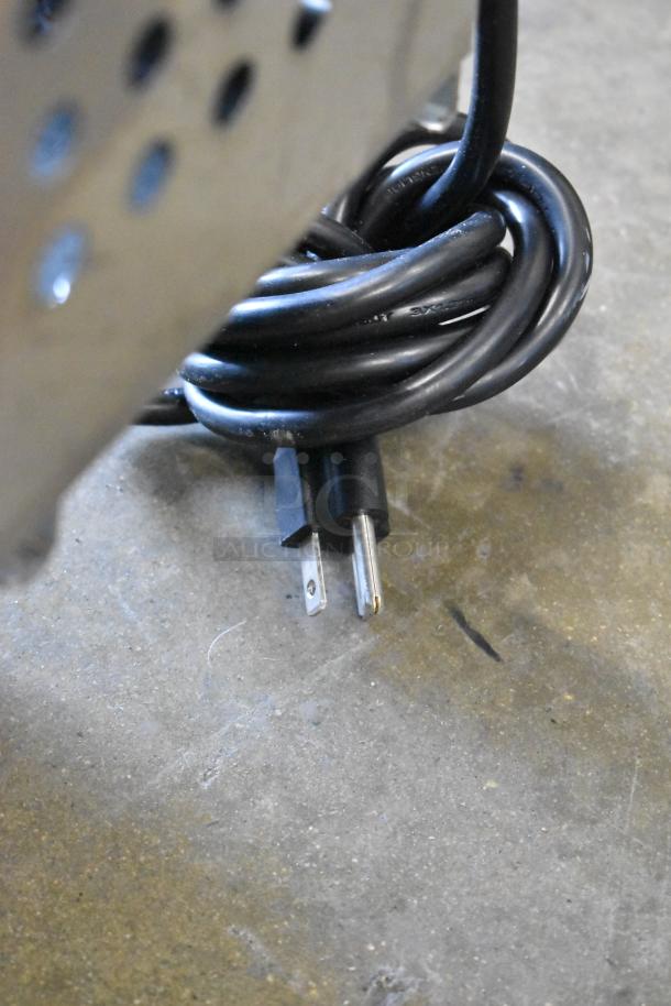 Coiled black power cord for Avantco 178APT71MHC prep table, 115 volts, visible on concrete floor.