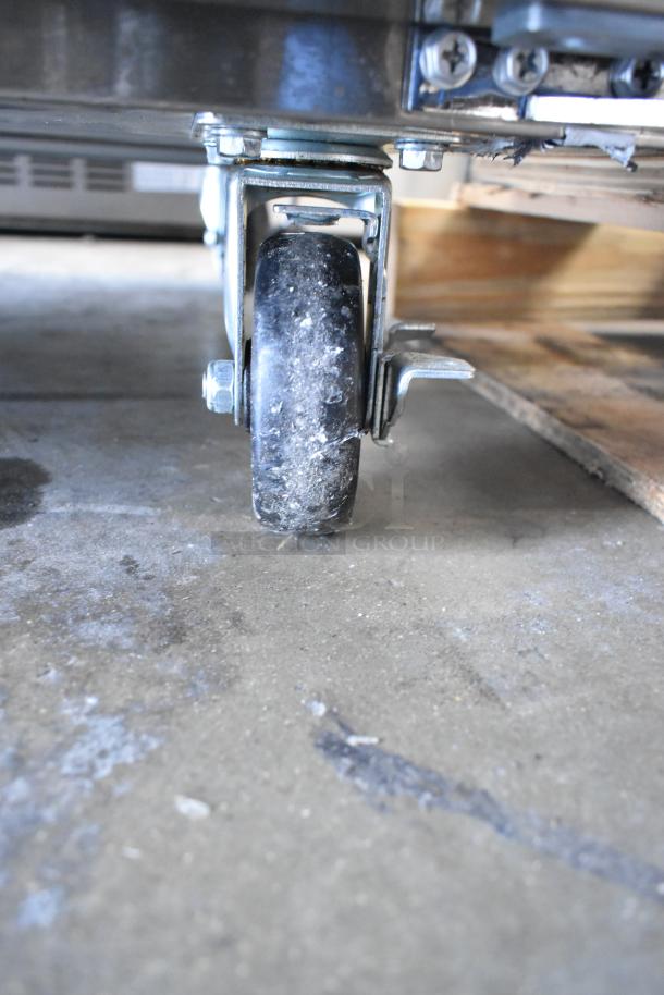 Commercial caster of 2024 Avantco 178APT71MHC sandwich prep table, scratch and dent condition.