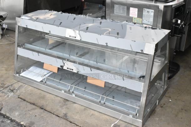 Hatco GRHD-4PD stainless steel dual shelf merchandiser, new with some dents. Protective film partially intact.