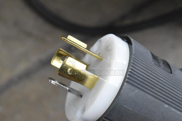 Close-up of a power plug for a Hatco GRHD-4PD stainless steel merchandiser. Features three prongs.
