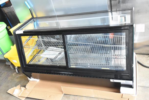 Brand new Avantco 360BCSS48HCB 48" black refrigerated bakery display case with LED lighting, visible shelves, minor packaging dents.