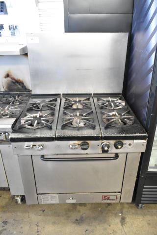Southbend stainless steel commercial gas 6-burner range with oven, backsplash. Used condition, minor surface wear.