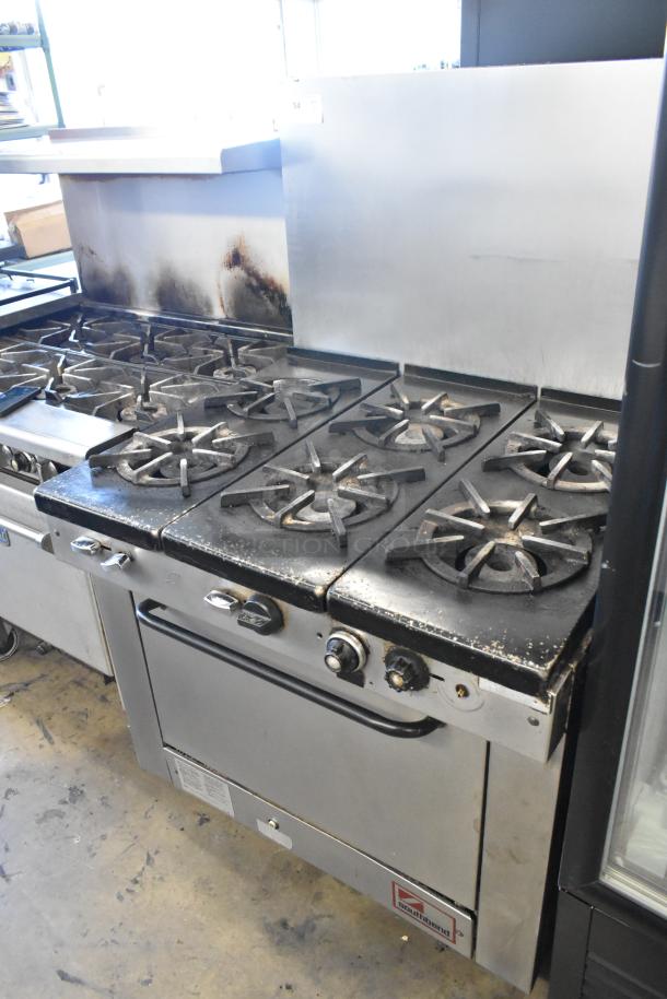 Southbend stainless steel commercial gas range with 6 burners, oven, and backsplash. Used condition with visible wear.