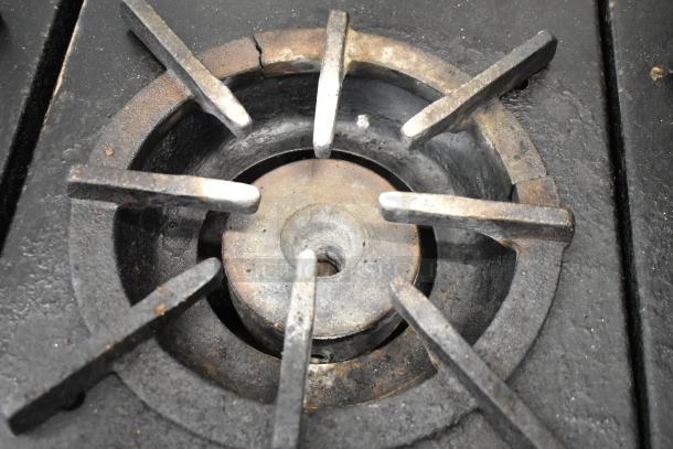 Southbend stainless steel commercial gas burner detail, showing one of six burners, slightly worn, solid construction.