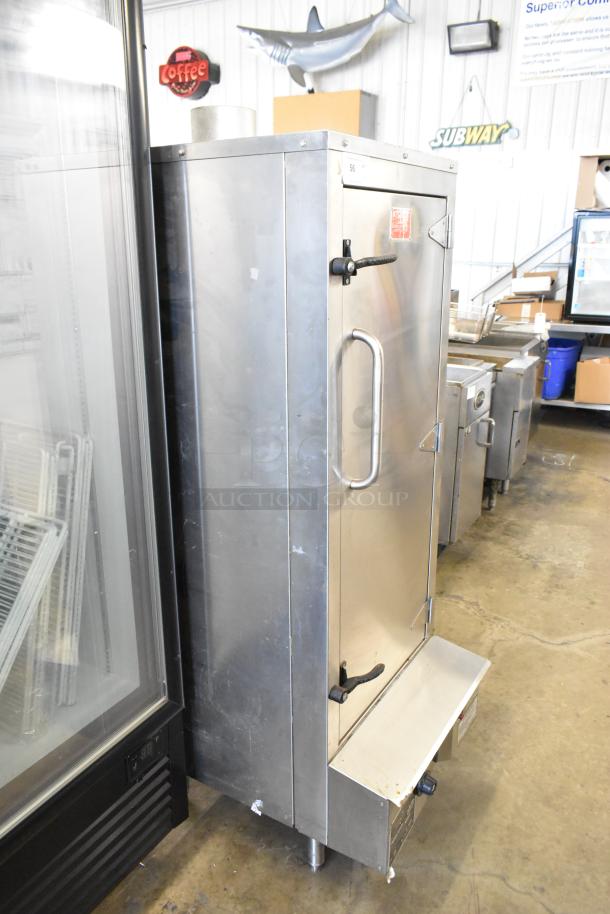 Town SM-24-R-SS-P stainless steel upright Chinese smoker, commercial propane gas powered, in used condition, visible markings.