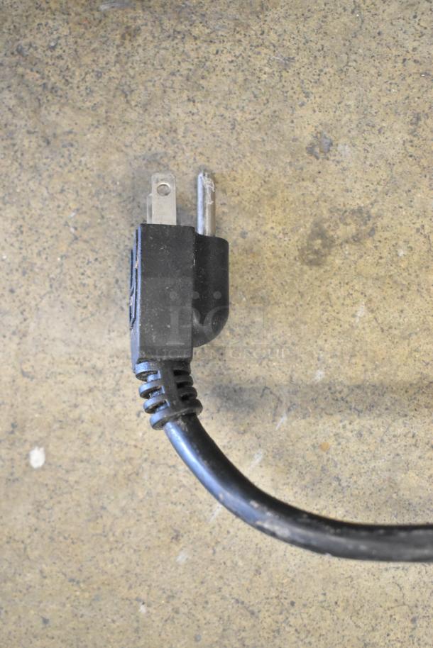 Close-up of a power plug for a 2019 Omcan SP200A Commercial Mixer, 115 Volts, with visible wear on the cord.