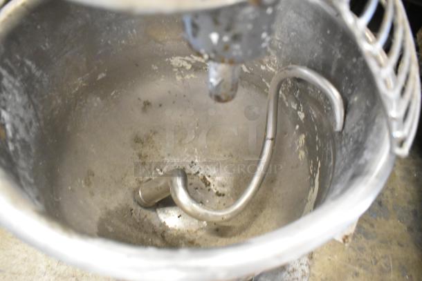 Metal commercial countertop 20-quart planetary dough mixer with stainless steel mixing bowl, bowl guard, and dough hook. 115 volts, 1 phase.