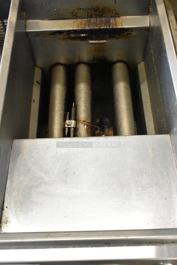 Royal RPT-50 stainless steel deep fat fryer, commercial grade, natural gas powered, visible wear, on casters for mobility.