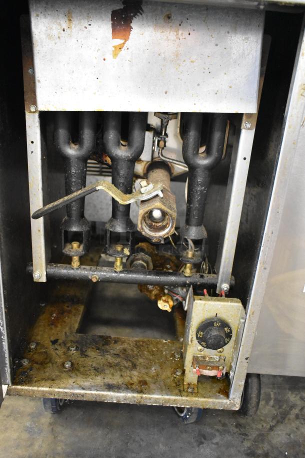 Royal RPT-50 stainless steel deep fat fryer, natural gas powered, on commercial casters, showing internal components and controls.