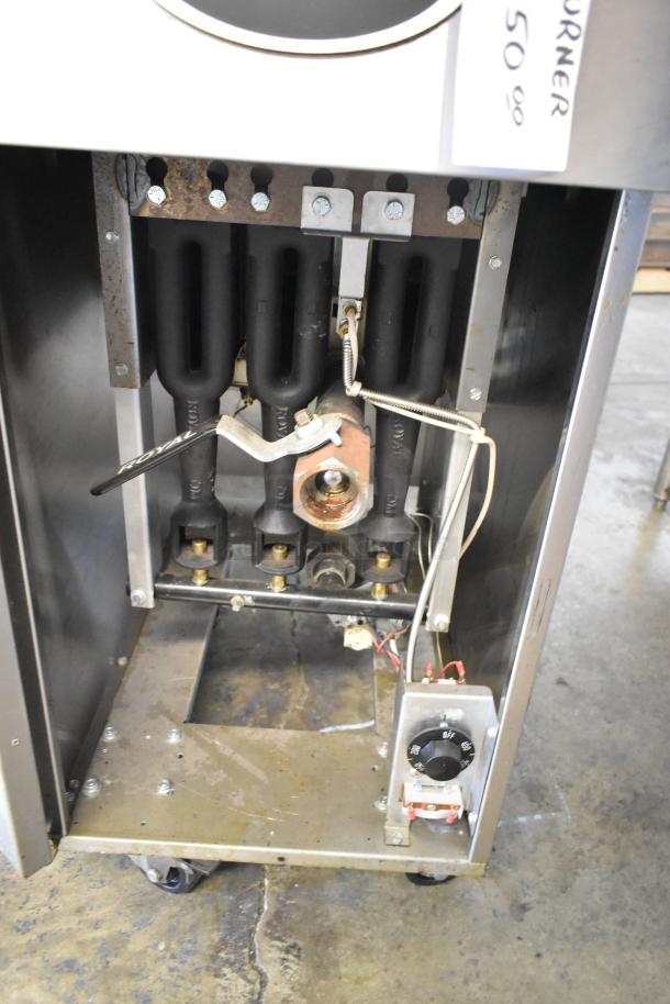 Royal REEF-35 natural gas deep fat fryer interior view, showing burners and wiring. In good condition on commercial casters.