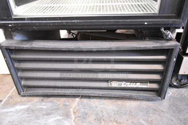 True GEM-26 commercial cooler with poly coated racks, single door. Visible True logo, 115 volts, 1 phase. Good condition.