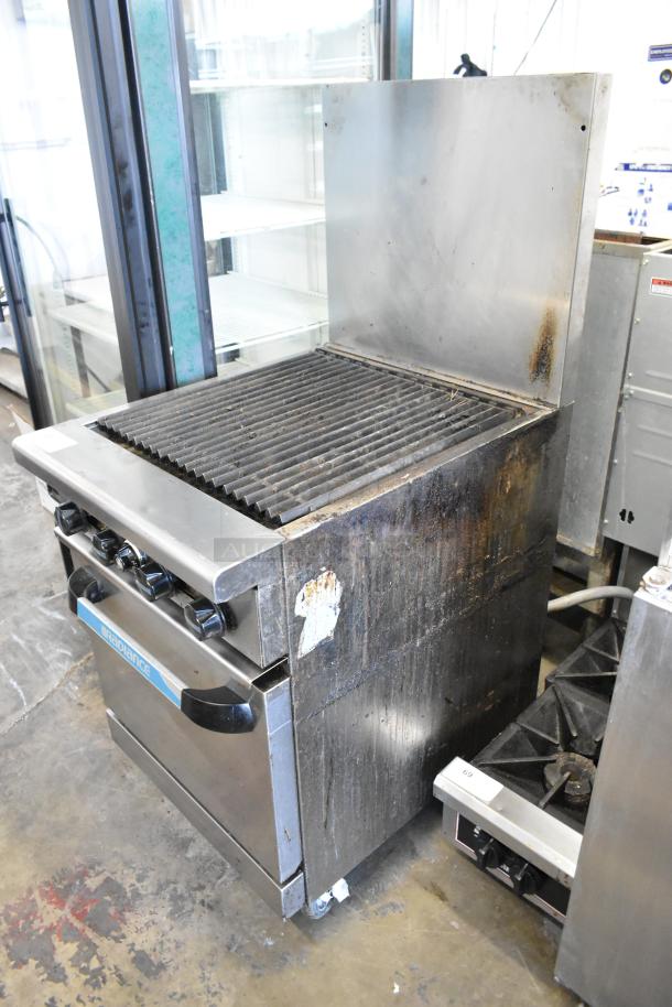 Radiance stainless steel commercial gas charbroiler with oven, backsplash, and casters; used condition, visible wear.