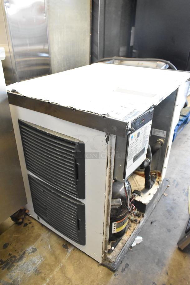 Scotsman C1030MA-32B stainless steel commercial ice head, 208/230 volts, 1 phase; visible wear, markings indicate model and specs.