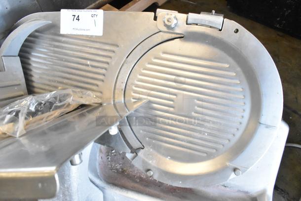 Hobart 2812 stainless steel commercial meat slicer. Visible tag indicates it's part of an auction lot. 115 volts, 1 phase.