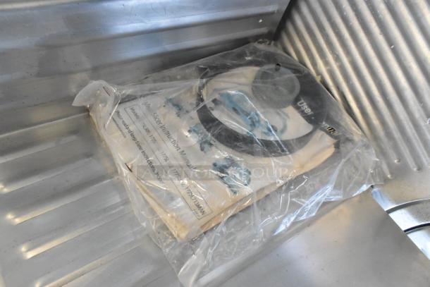 Stainless steel countertop meat slicer, Hobart 2812 model, 115V, commercial use. Includes instruction manual in plastic.