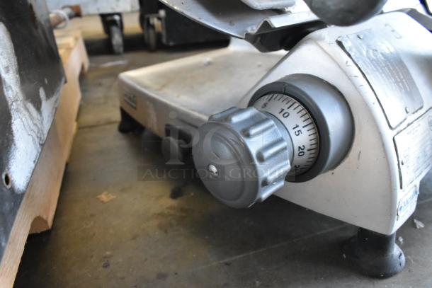 Hobart 2812 stainless steel commercial meat slicer, featuring a dial knob. Model label visible, some wear present.