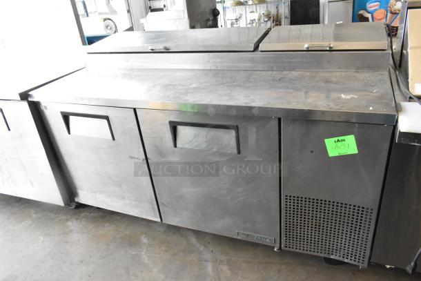 2017 True TPP-67 stainless steel commercial pizza prep table with casters, 115 volts, 1 phase, green label attached.