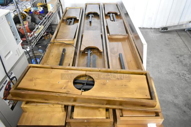 8 brand new scratch and dent wooden folding tables, natural finish, visible support structure, ready for assembly.