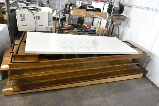 Brand new wooden folding table, 8 units, minor scratches and dents, stacked. Ideal for multi-purpose use.