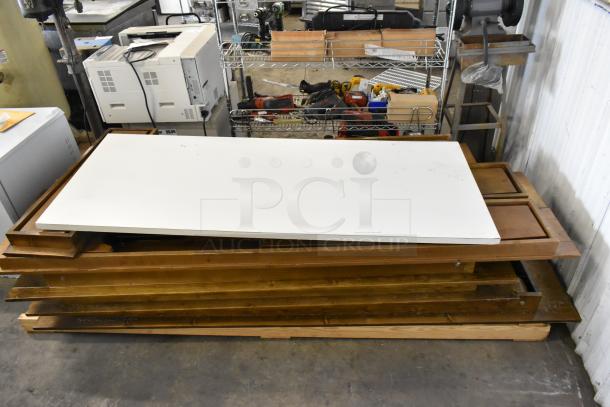 Brand new wooden folding table with minor scratches and dents. Stack of eight. Bid valued at 8 times your offer.