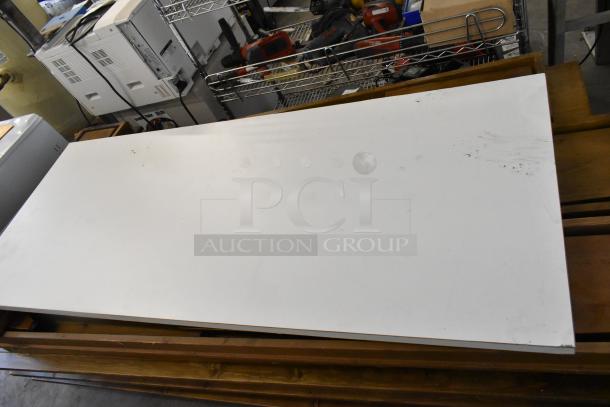 Brand new wooden folding table with minor scratches and dents. White top, stackable design, durable construction.