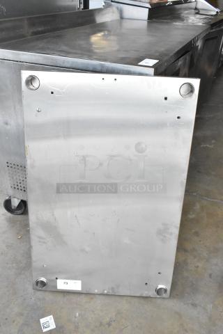 Stainless steel panel with holes for mounting. Shows wear with scratches and scuffs. Label reads "79 QTY 1."
