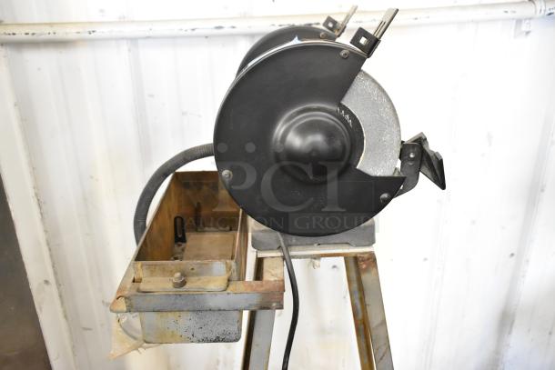 Porter Cable PCB575BG bench grinder, 120V, 1 phase. Black casing, mounted on stand, visible wear, functional condition.