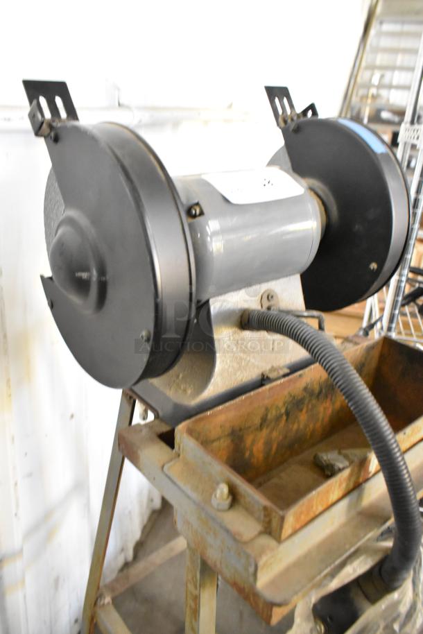 Porter Cable PCB575BG Bench Grinder, 120V, 1 Phase. Visible wear, mounted on stand. Gray housing with dual grinding wheels.
